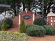 Glenview community entrance with brick signage, manicured landscaping, and decorative bushes at 6445 Glen Oaks Ln, Sandy Springs, GA 30328