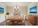 Staged dining room with decorative lighting, neutral wall color, and coordinated furnishings at 6445 Glen Oaks Ln, Atlanta, GA 30328