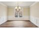 Formal dining room with hardwood floors, wainscoting, and elegant lighting at 6445 Glen Oaks Ln, Sandy Springs, GA 30328