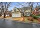 Charming two-story home with a mix of siding and stone, plus a well-manicured front yard at 6445 Glen Oaks Ln, Atlanta, GA 30328