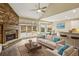 Cozy living room with a stone fireplace, hardwood floors, and ample natural light at 6445 Glen Oaks Ln, Sandy Springs, GA 30328