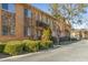 Apartment building exterior with well-manicured landscaping and street parking at 100 Biscayne Nw Dr # E1, Atlanta, GA 30309