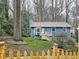 Charming blue home with a picket fence and well-maintained lawn and inviting front porch at 2336 Vistamont Dr, Decatur, GA 30033