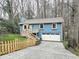 Two-story blue home with a charming white garage door, picket fence, and well-maintained lawn at 2336 Vistamont Dr, Decatur, GA 30033