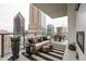 Outdoor balcony features modern furniture, fireplace and stunning views of the city skyline at 40 12Th Ne St # 1503, Atlanta, GA 30309