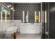 Modern bathroom featuring a soaking tub, double sinks, and stylish geometric wallpaper at 40 12Th Ne St # 1503, Atlanta, GA 30309