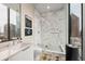 Modern bathroom features a glass-enclosed shower with marble accents and city views at 40 12Th Ne St # 1503, Atlanta, GA 30309