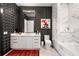 Stylish bathroom with bold geometric wallpaper, marble accents, and a modern vanity at 40 12Th Ne St # 1503, Atlanta, GA 30309