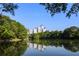 Beautiful city skyline view reflecting on a pristine lake surrounded by lush greenery at 40 12Th Ne St # 1503, Atlanta, GA 30309