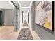 Long, carpeted hallway with artwork and modern lighting fixtures at 40 12Th Ne St # 1503, Atlanta, GA 30309