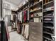 Large walk-in closet featuring custom shelving, drawers, and ample storage space at 40 12Th Ne St # 1503, Atlanta, GA 30309