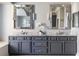 Bathroom with double vanity, marble countertops, and decorative framed mirrors at 6955 Laurel Oak Dr, Suwanee, GA 30024