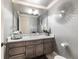 Gray bathroom featuring a vanity with granite countertop, large mirror and decorative wall art at 6955 Laurel Oak Dr, Suwanee, GA 30024