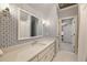 Bathroom featuring patterned wallpaper, a white vanity, mirror and white tile floors at 6955 Laurel Oak Dr, Suwanee, GA 30024