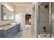 Elegant bathroom with a marble countertop, vessel sink, and tiled walk-in shower at 6955 Laurel Oak Dr, Suwanee, GA 30024