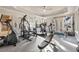 Well-equipped home gym with various exercise machines and natural light at 6955 Laurel Oak Dr, Suwanee, GA 30024