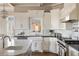 Modern kitchen featuring white cabinetry, marble backsplash, a farmhouse sink, and stainless steel appliances at 6955 Laurel Oak Dr, Suwanee, GA 30024