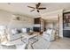 Comfortable living room featuring a wet bar, neutral paint, and lots of natural light at 6955 Laurel Oak Dr, Suwanee, GA 30024