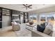 Bright living room with built-in shelving, neutral paint, and lots of natural light at 6955 Laurel Oak Dr, Suwanee, GA 30024