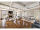 Open concept living room with coffered ceilings, fireplace, and windows with bright natural light at 6955 Laurel Oak Dr, Suwanee, GA 30024