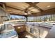 Gourmet outdoor kitchen area with stone countertop, sink, stainless steel grill, and mini fridge at 6955 Laurel Oak Dr, Suwanee, GA 30024