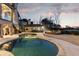 Twilight view of a fabulous pool featuring an outdoor bar and fire pit area at 6955 Laurel Oak Dr, Suwanee, GA 30024