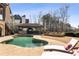 Resort-style pool with a swim-up bar, outdoor kitchen, and fire pit lounge area for upscale outdoor living at 6955 Laurel Oak Dr, Suwanee, GA 30024