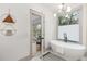 A bright bathroom with a modern tub and geometric wall art, leading to another room at 1055 Ormewood Se Ave, Atlanta, GA 30316