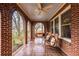 Inviting brick porch with tile flooring, a swing, and comfortable seating at 126 Greenwood Pl, Decatur, GA 30030