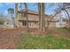 Home's backyard features mature trees and partial view of the house at 1429 Christiana Dr, Lawrenceville, GA 30043