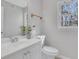 Bathroom featuring a white vanity, toilet, mirror, and window at 1429 Christiana Dr, Lawrenceville, GA 30043