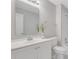 Bathroom features white vanity, sink, toilet, decorative mirror, and walk-in shower at 1429 Christiana Dr, Lawrenceville, GA 30043