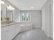 Bright bathroom with double vanity, soaking tub, and marble floors at 1429 Christiana Dr, Lawrenceville, GA 30043