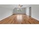 Large bedroom offers hardwood floors, a ceiling fan, and a bright window at 1429 Christiana Dr, Lawrenceville, GA 30043