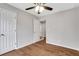 This bedroom features hardwood floors, neutral paint, ceiling fan and closet space at 1429 Christiana Dr, Lawrenceville, GA 30043
