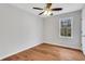 Bright bedroom features hardwood floors, neutral paint, ceiling fan, and a window at 1429 Christiana Dr, Lawrenceville, GA 30043