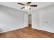 This bedroom features hardwood floors, neutral paint, ceiling fan, closet and door at 1429 Christiana Dr, Lawrenceville, GA 30043