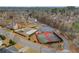 Aerial view of community tennis courts, volleyball court, pool, and nearby parking in a wooded neighborhood at 1429 Christiana Dr, Lawrenceville, GA 30043