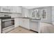 Kitchen featuring white cabinets, stainless steel appliances, granite countertops and tile floors at 1429 Christiana Dr, Lawrenceville, GA 30043