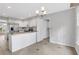Bright kitchen with a stainless steel refrigerator, white cabinets, and a view to the breakfast area at 1429 Christiana Dr, Lawrenceville, GA 30043