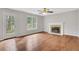 Living Room with Fireplace, hardwood floors, ceiling fan, and door to back yard at 1429 Christiana Dr, Lawrenceville, GA 30043