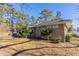 Side view of a single-story brick house, showcasing its simple landscaping and a paved driveway at 3517 Hyland Dr, Decatur, GA 30032
