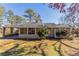 Charming brick home featuring a covered carport and a well-maintained front yard with mature trees at 3517 Hyland Dr, Decatur, GA 30032