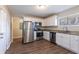 Well-lit kitchen with stainless steel appliances, granite countertops, and white cabinetry at 3517 Hyland Dr, Decatur, GA 30032