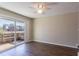 Sunlit room with hardwood floors, a ceiling fan, and large sliding glass doors opening to a wooden patio at 3517 Hyland Dr, Decatur, GA 30032