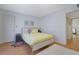 Bedroom with bright yellow bed, wood floors, and white walls at 5678 Kingsport Dr, Sandy Springs, GA 30342