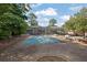 Community pool surrounded by lush greenery, ideal for summer enjoyment and relaxation at 5678 Kingsport Dr, Sandy Springs, GA 30342