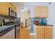 The kitchen features stainless steel appliances and an adjacent hallway with stairs at 5678 Kingsport Dr, Sandy Springs, GA 30342