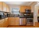 Kitchen featuring stainless steel appliances, wooden cabinets, and tile backsplash at 5678 Kingsport Dr, Sandy Springs, GA 30342