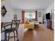 A view from the dining nook overlooking the bamboo floors of a modern living room at 5678 Kingsport Dr, Sandy Springs, GA 30342